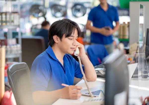 Turn-quotes-into-sales banner for blog showing parts advisor giving someone a parts quote over the phone